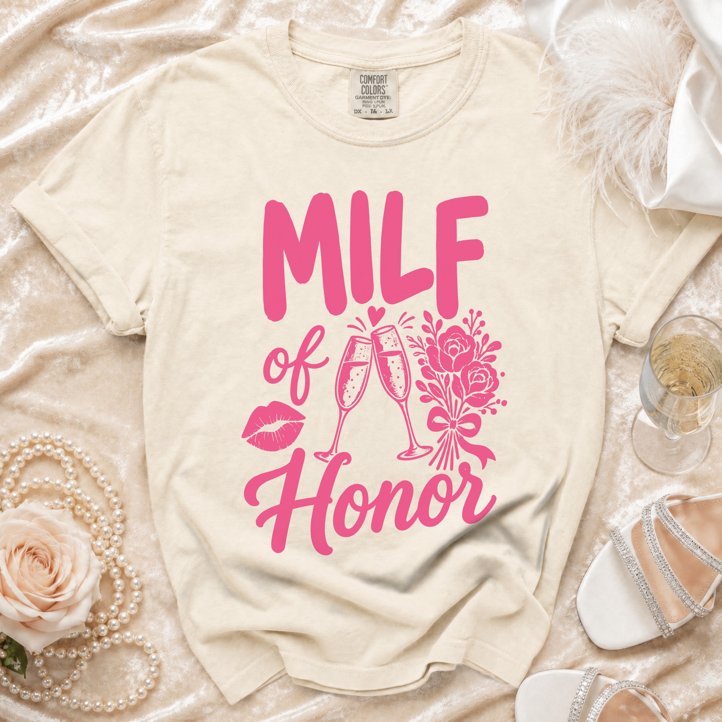 Cream t-shirt with "MILF of Honor" text, champagne glasses, lips, and flowers.