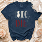 Navy t-shirt with white and red "BRIDE OR DIE" text and veil graphic.