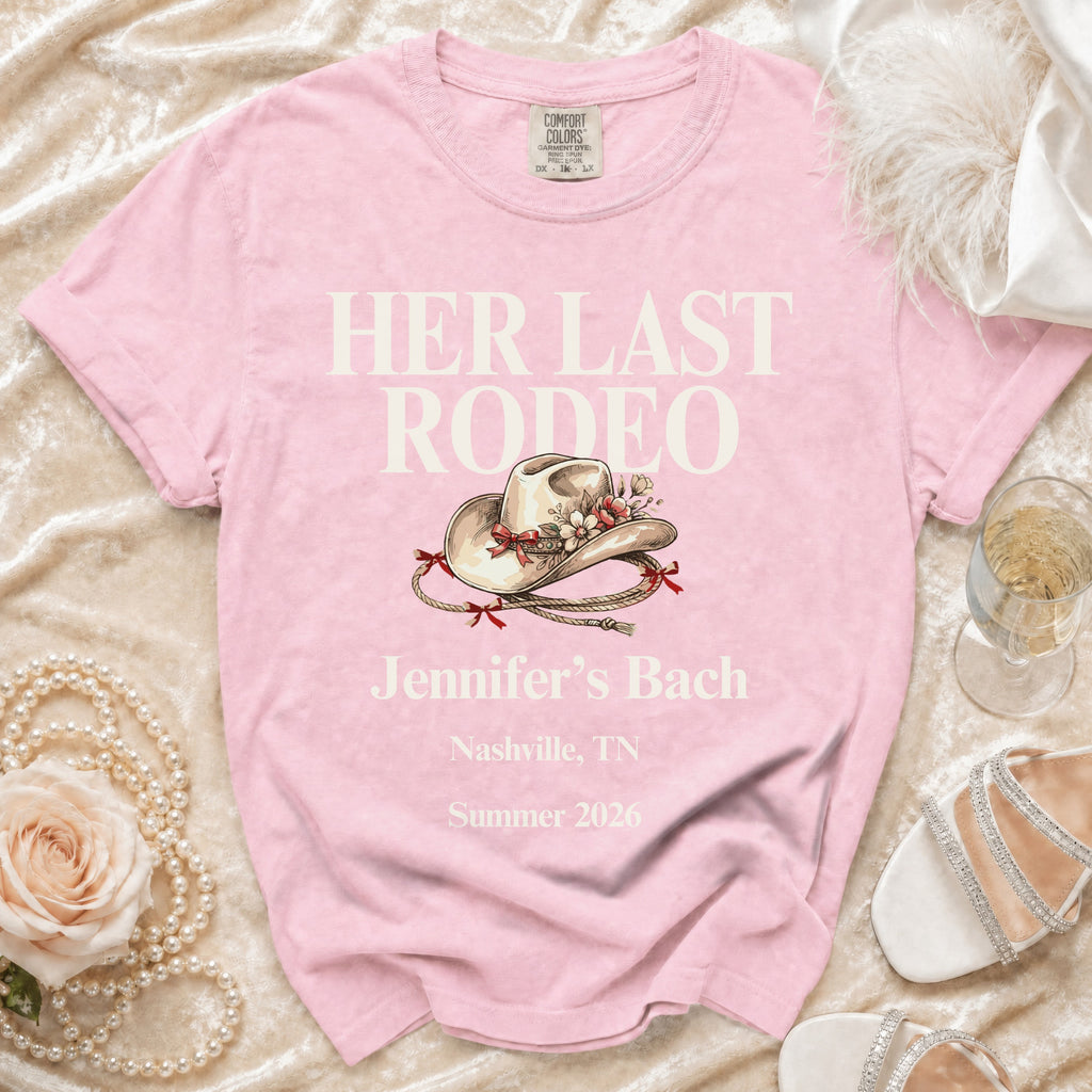 Pink t-shirt with "Her Last Rodeo" text, cowgirl hat, and event details.