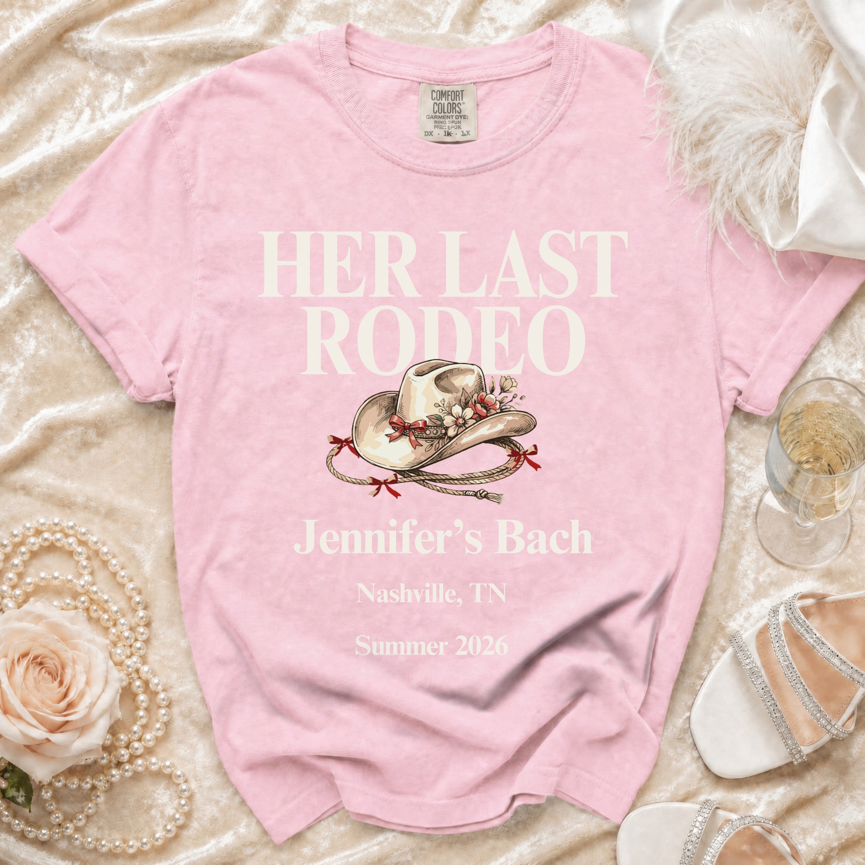 Pink t-shirt with "Her Last Rodeo" text, cowgirl hat, and event details.