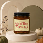 Brown glass candle labeled "Maid of Honor Recovery" with "Treatment Ongoing" and "Vowed."