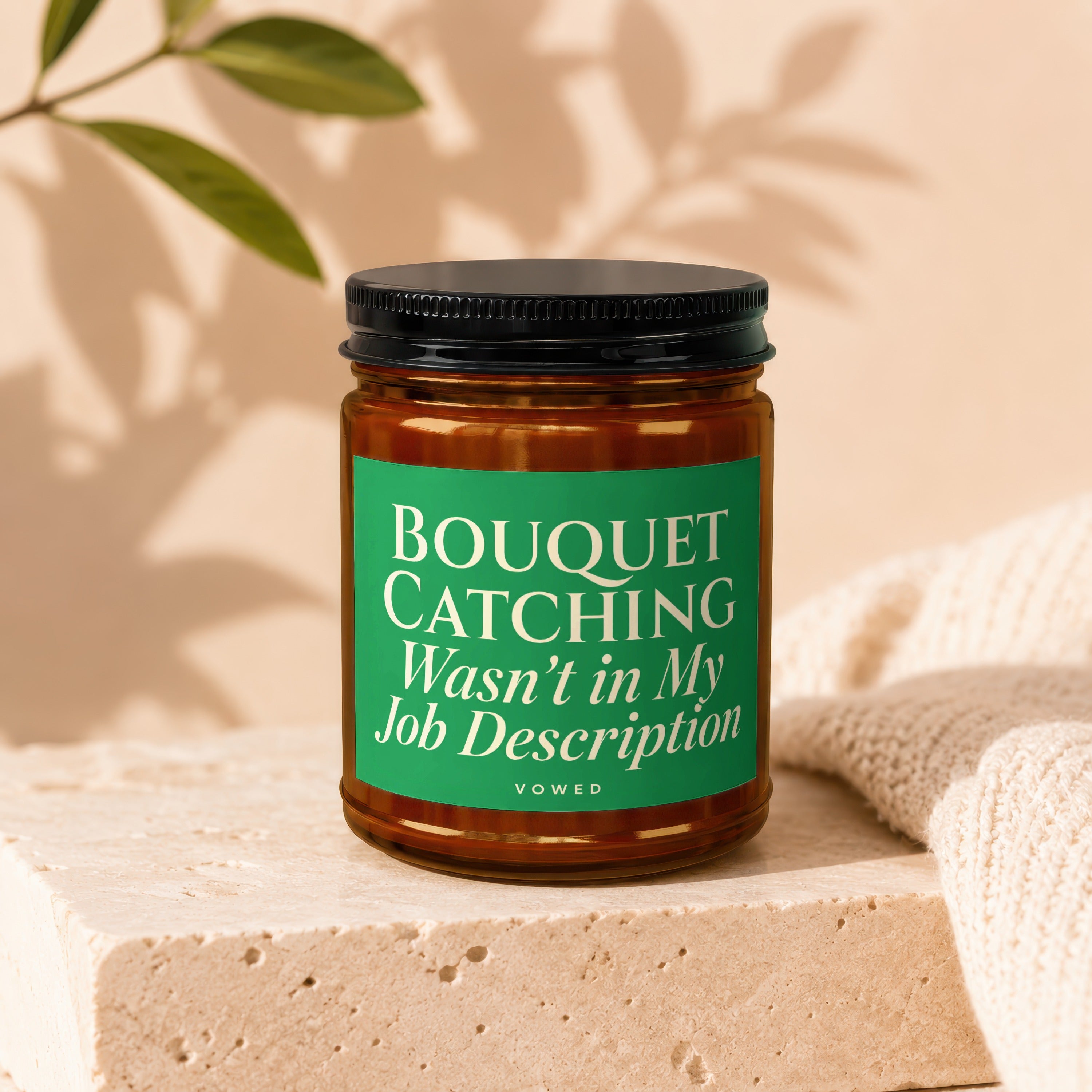 Glass jar candle with green label that reads "Bouquet Catching Wasn't in My Job Description Vowed."