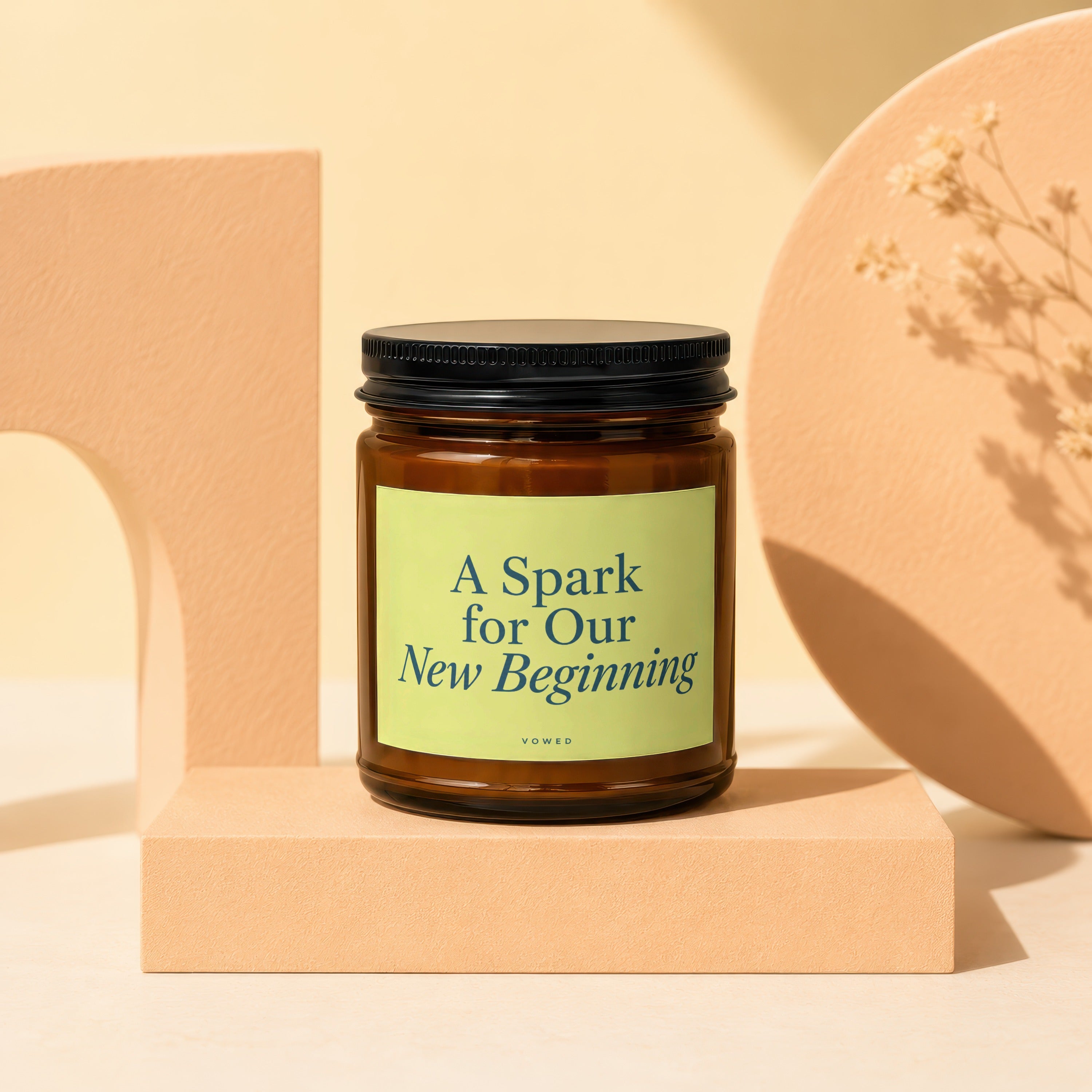 Glass jar candle with label reading "A Spark for Our New Beginning" by Vowed.
