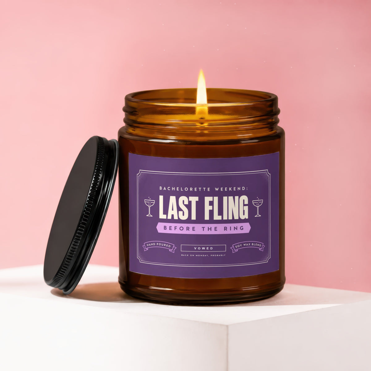 Bachelorette weekend candle, "Last Fling Before The Ring," with a lit wick.
