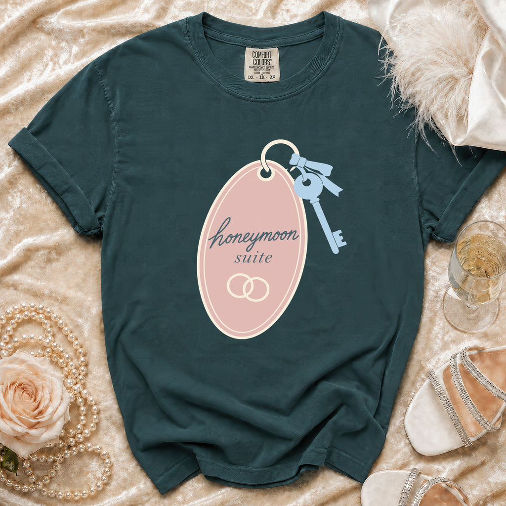 Dark green t-shirt with "honeymoon suite" graphic on a pink oval and a key.