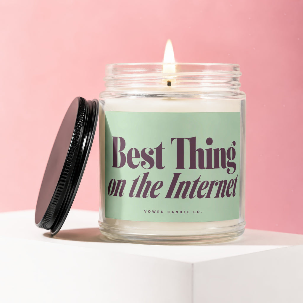 Candle with text "Best Thing on the Internet" on a light green label.