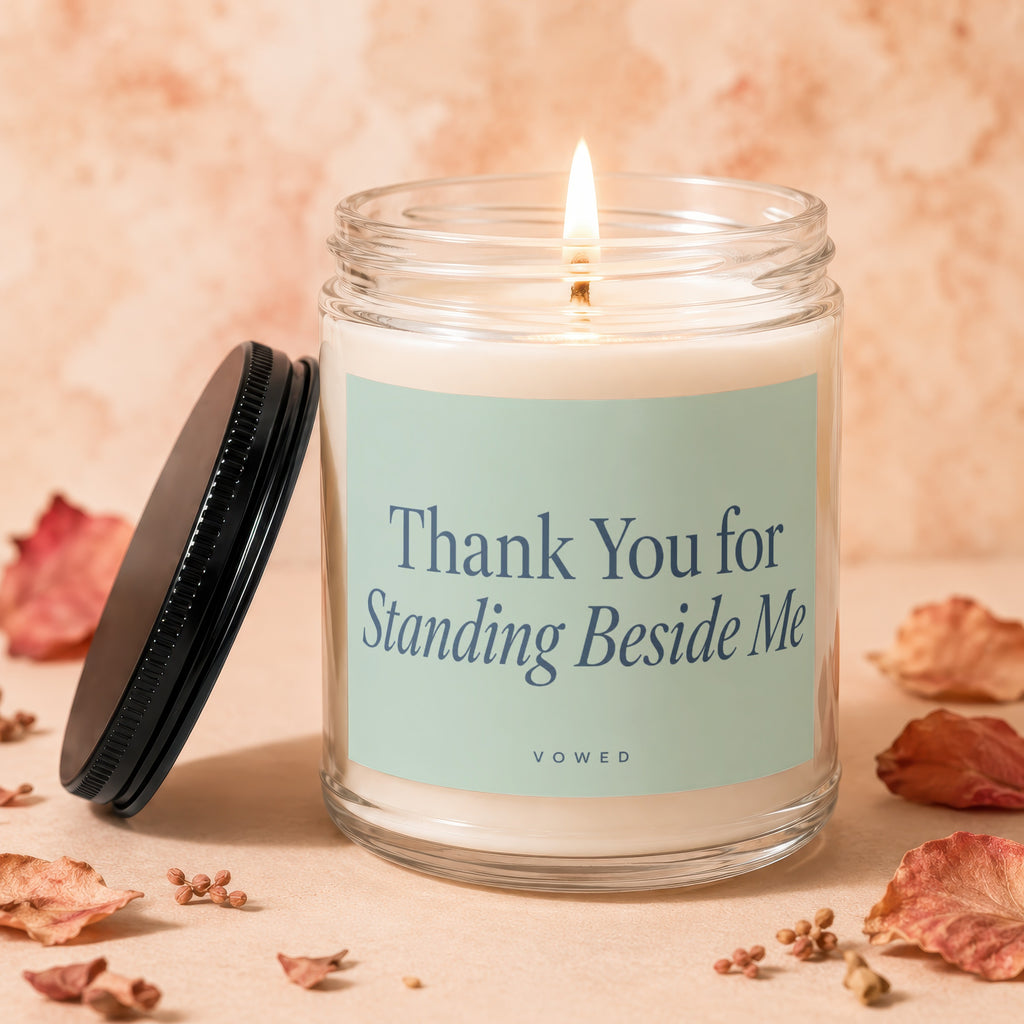 Glass candle with lit wick, inscribed "Thank You for Standing Beside Me"