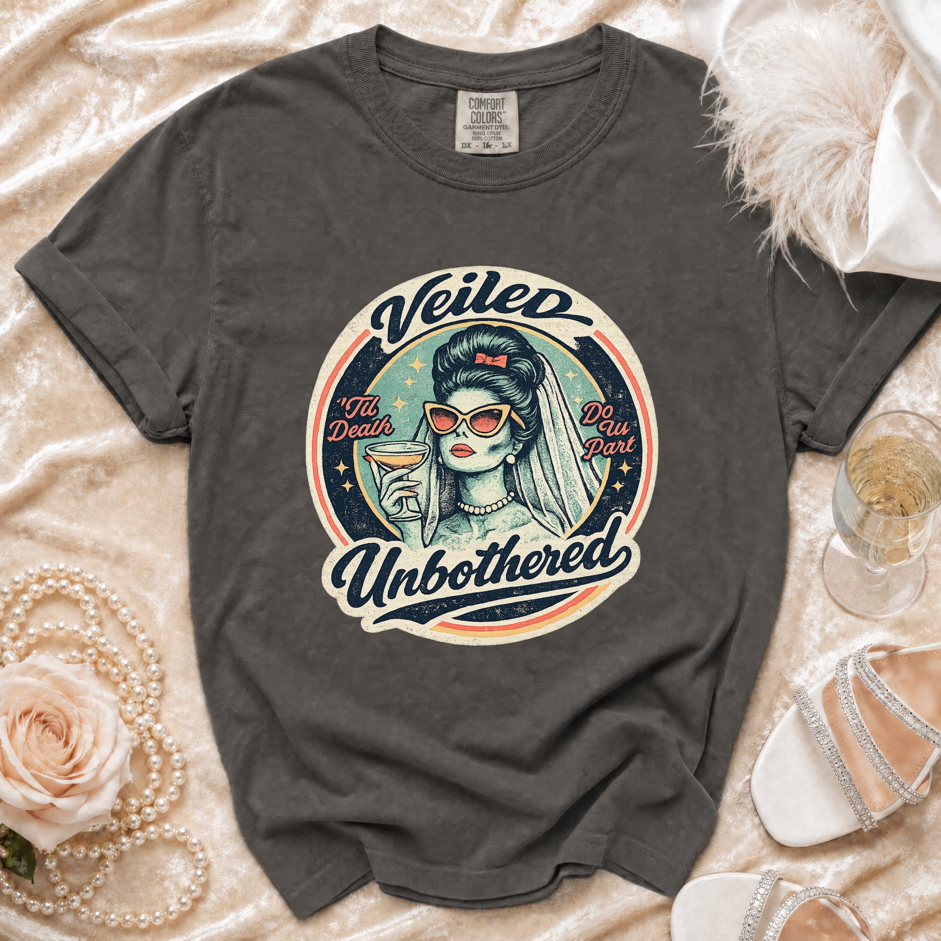 Dark gray t-shirt with "Veiled" and "Unbothered" design of a bride.