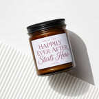 Amber candle in jar with white label reading "Smells Like Happily Ever After Starts Here".