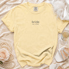 Yellow t-shirt with "bride est. 2026" printed on it.