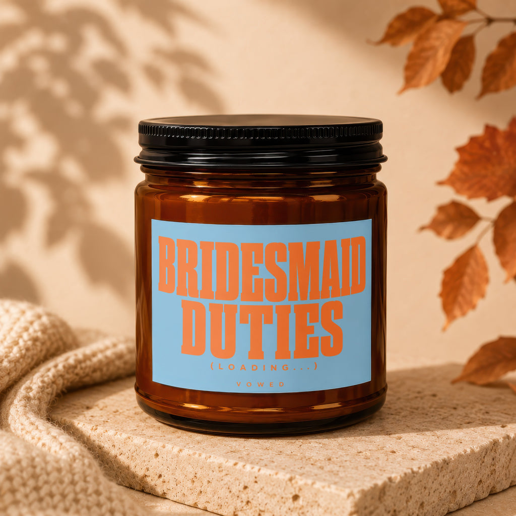 Brown glass candle with orange text "BRIDESMAID DUTIES (LOADING...)" below "VOWED".