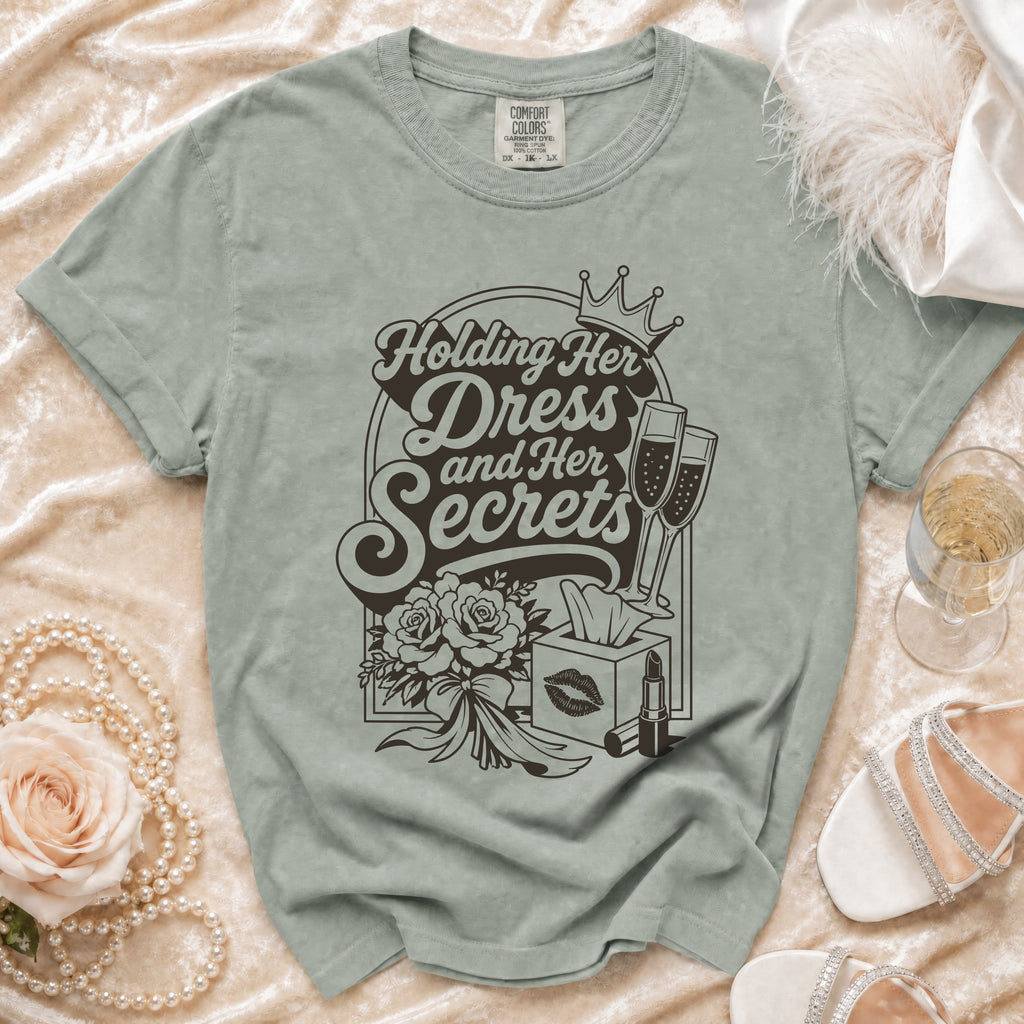 T-shirt graphic "Holding Her Dress and Her Secrets" with champagne and makeup.