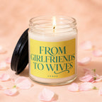 Candle with dark lid and yellow label saying "From Girlfriends To Wives".