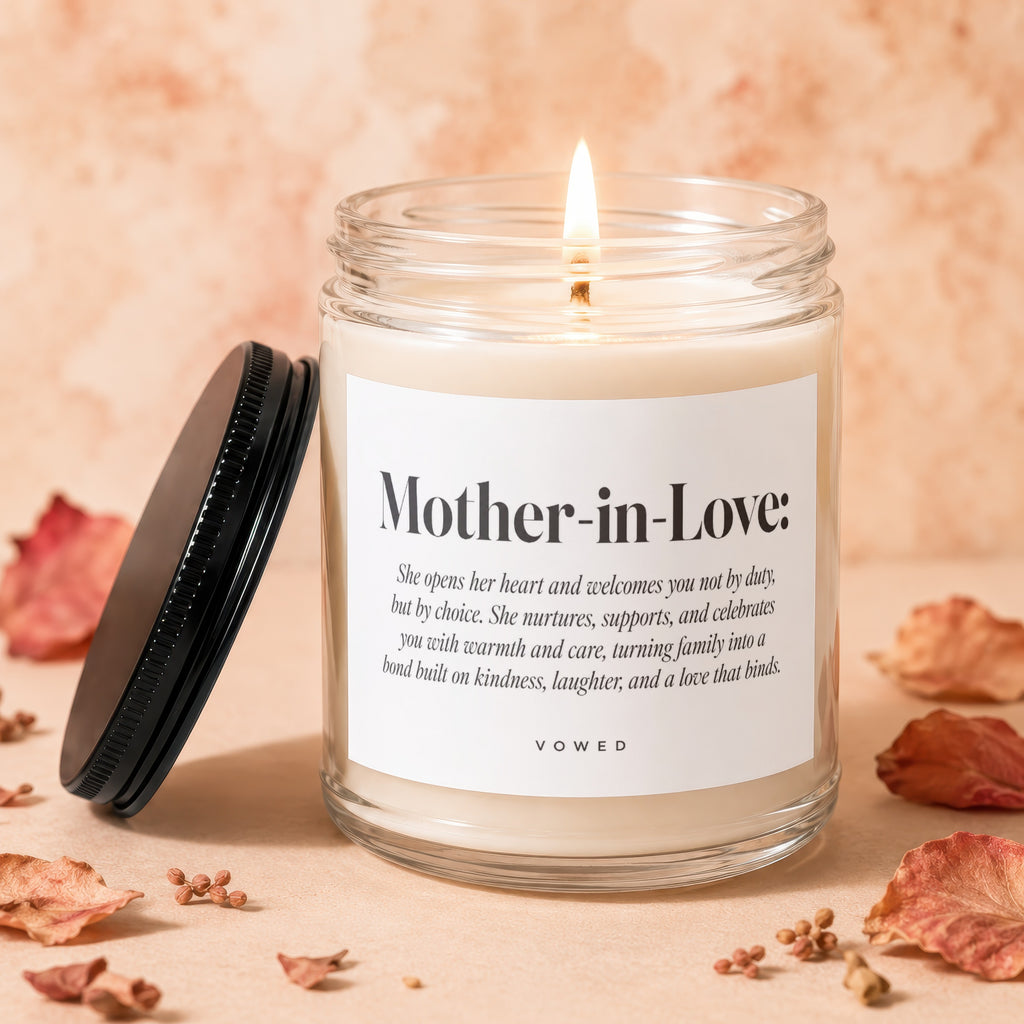 Glass jar candle with lit wick and "Mother-in-Love" text.