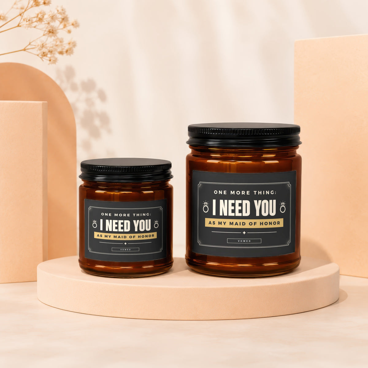 Two amber glass candles with black lids display "I NEED YOU AS MY MAID OF HONOR" labels.