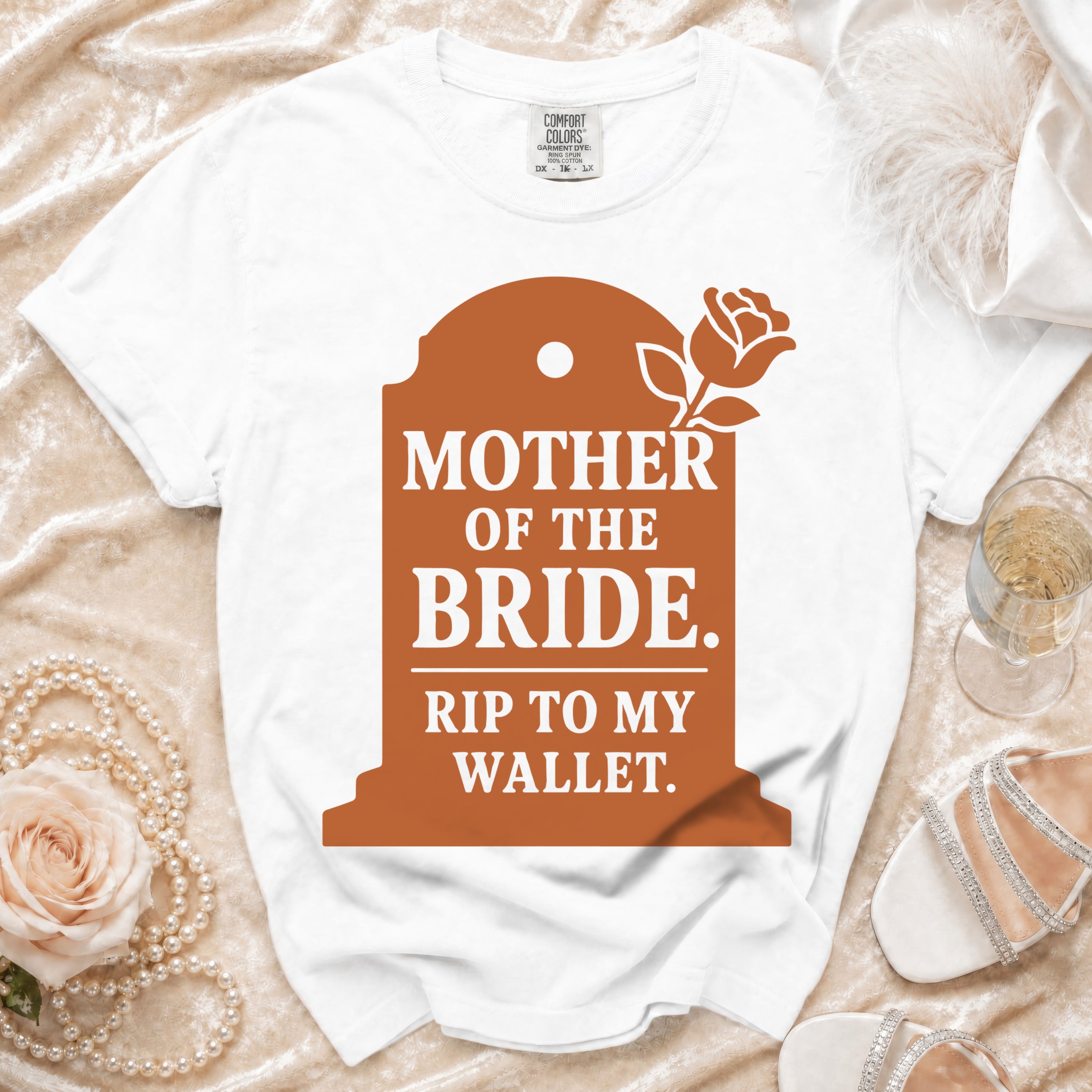 White t-shirt with "Mother of the Bride. Rip to my wallet." text on a tombstone graphic.