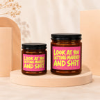 Two soy wax candles with pink labels reading "Look at you getting married and shit".