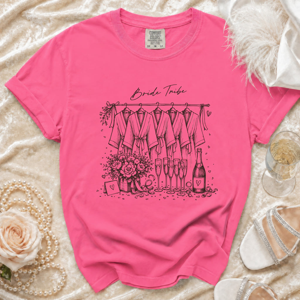 Pink t-shirt with "Bride Tribe" sketch of robes, flowers, champagne, and hearts.