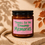 Amber jar candle with pink label reading "Thanks for the trauma memories" and "VOWED"