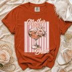 Orange t-shirt with "Mother of the Bride" graphic featuring a champagne coupe and flowers.