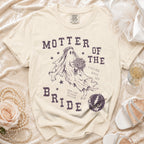 Cream t-shirt with "MOTHER OF THE BRIDE" text, ghost bride graphic, and bolt logo.