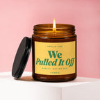 Amber glass candle with yellow label reading "Smells like We Pulled It Off".