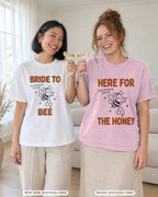 Bride and crew toasting in the Bride To Bee & Here For The Honey bachelorette shirts