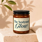 Candle labeled "Smells Like The Newlywed Glow" with "It's Not The Lighting" and "Vowed".