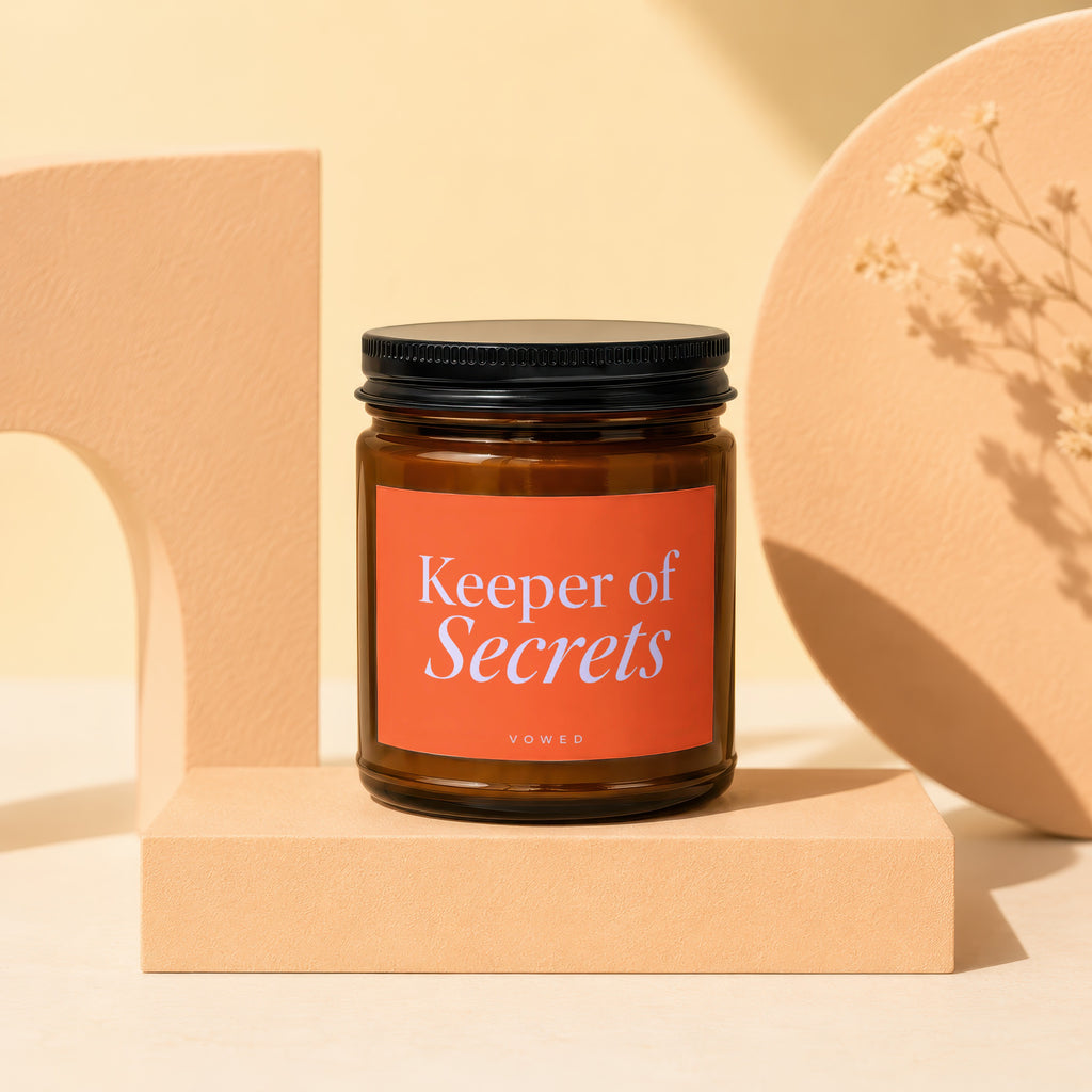 Amber glass candle labeled "Keeper of Secrets" by Vowed.