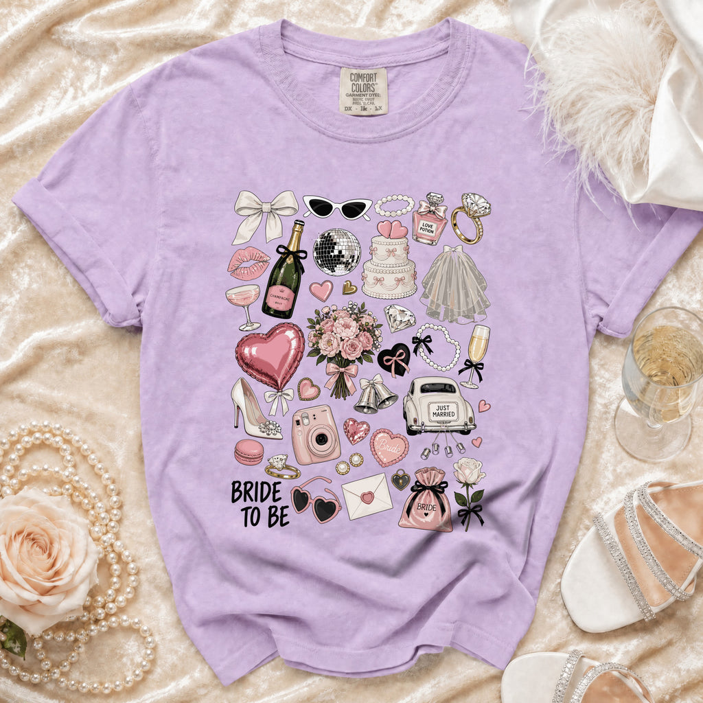 Purple t-shirt with "Bride To Be" and wedding-themed illustrations.