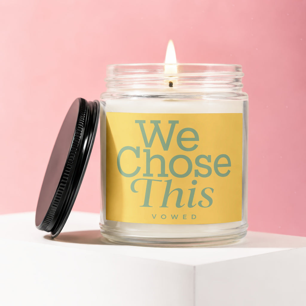 Glass candle with yellow label that reads "We Chose This" and "vowed"