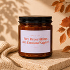 Amber jar candle with label reading "Smells Like Free Dress Fittings and Emotional Support Vowed".