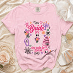 Pink t-shirt with "Bride" and "too cute to spook" graphics featuring a ghost bride and Halloween icons.