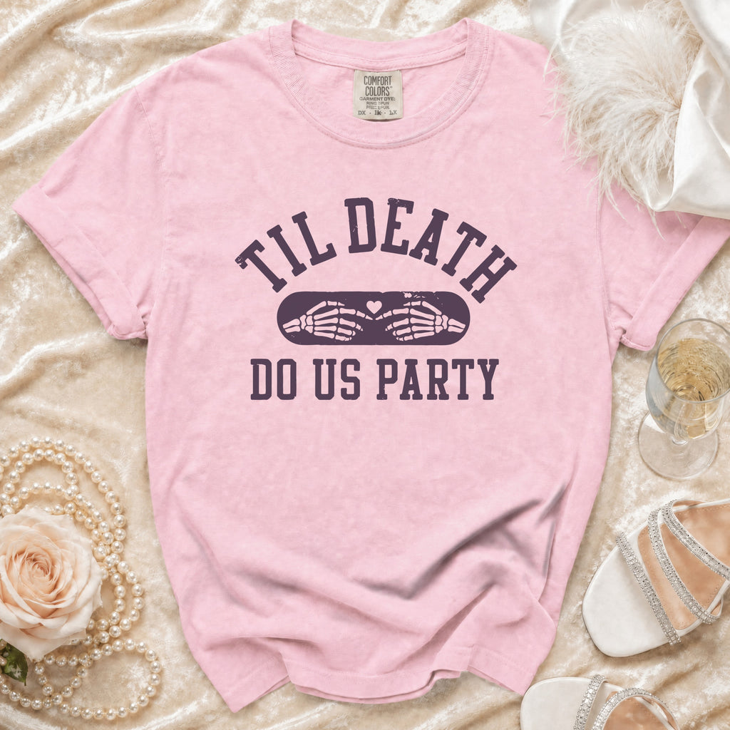 Pink t-shirt with "Til Death Do Us Party" text and skeleton hands forming a heart.