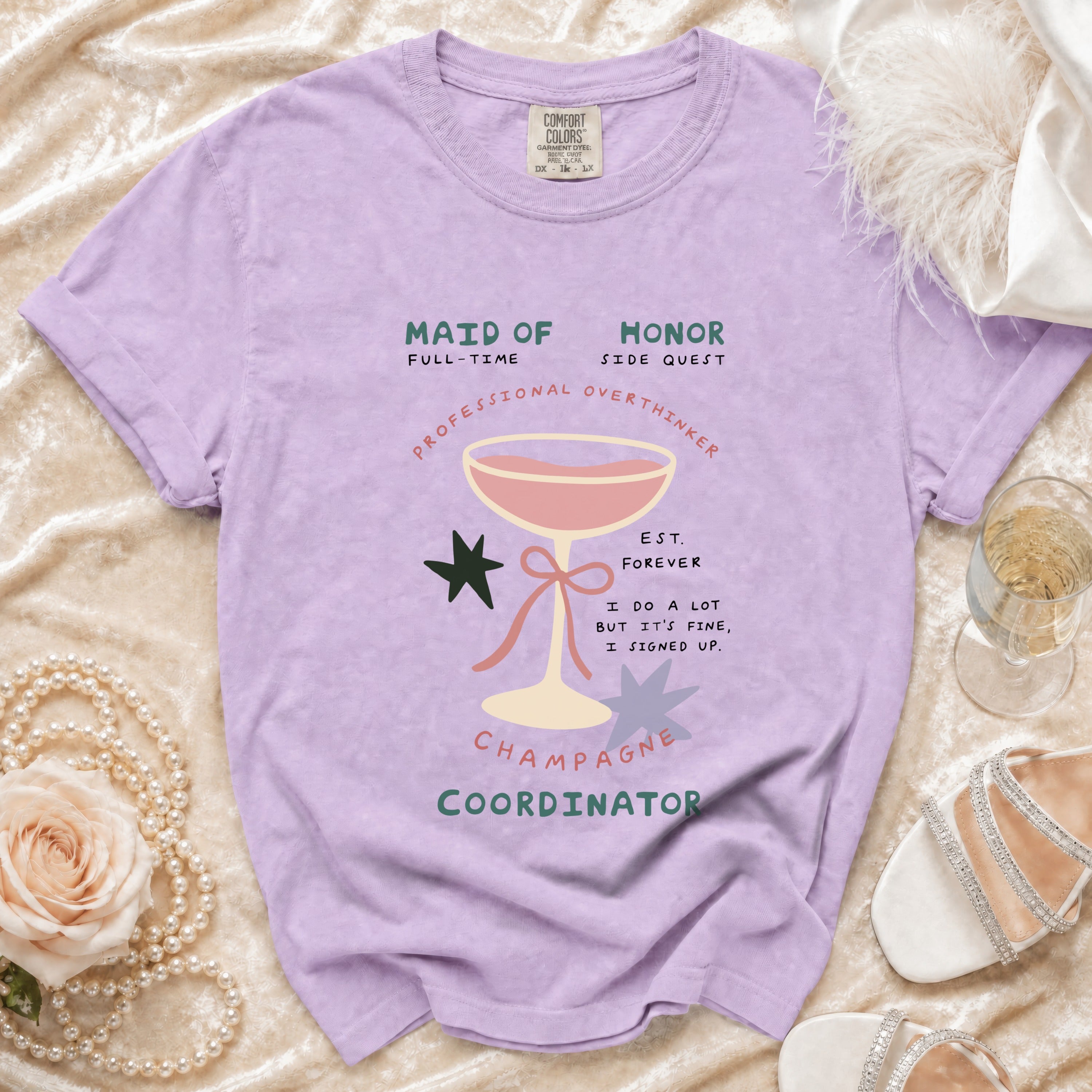 Lavender t-shirt with graphic: "Maid of Honor, Full-Time Side Quest, Professional Overthinker, Champagne Coordinator."