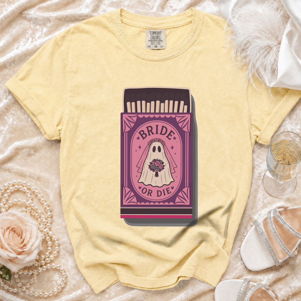 Yellow t-shirt with a "Bride or Die" ghost bride graphic on a matchbox.