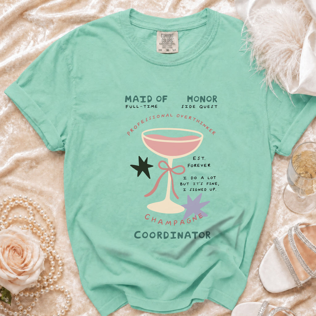 Seafoam green t-shirt with "Maid of Honor, Champagne Coordinator" text and graphics.