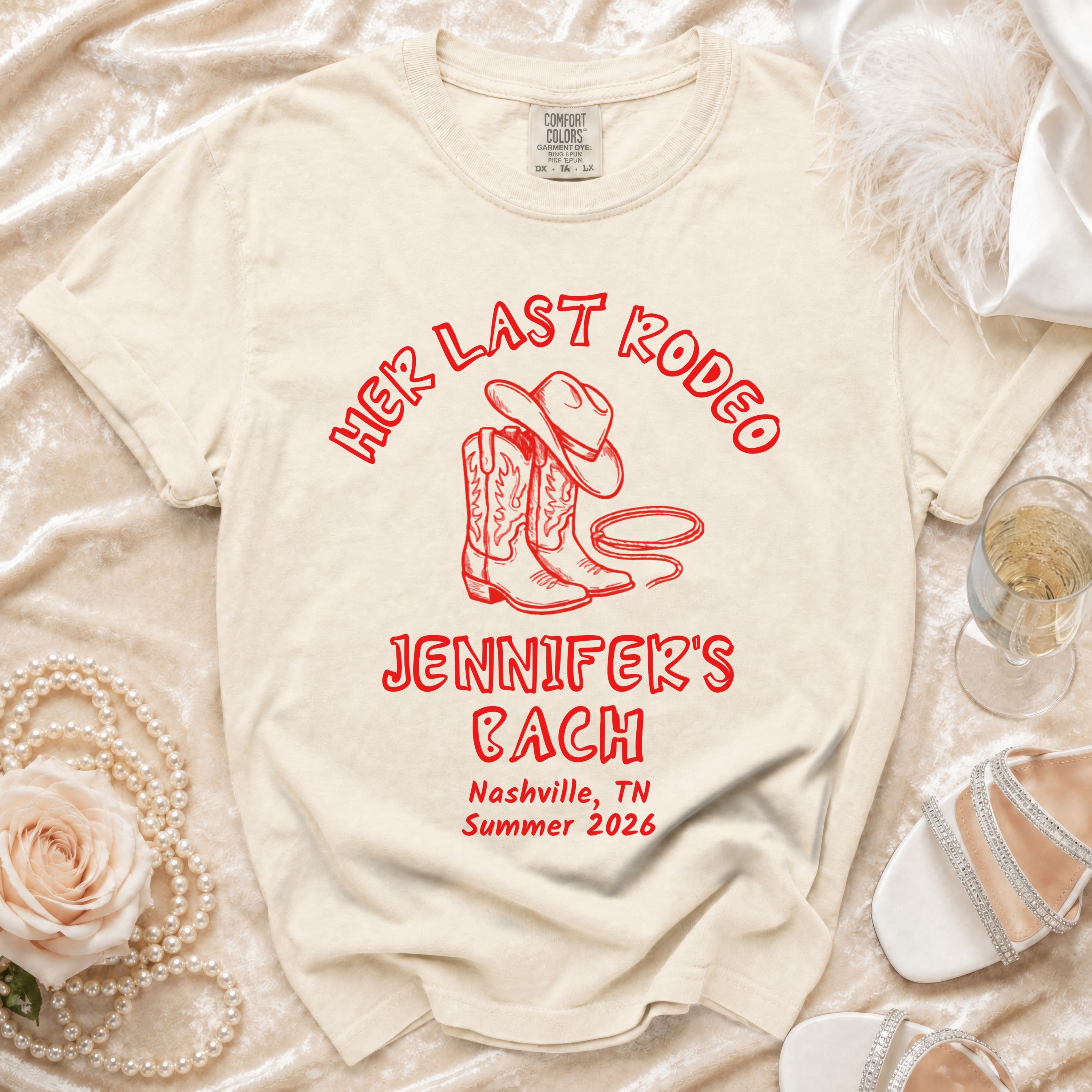 Cream t-shirt with "Her Last Rodeo Jennifer's Bach Nashville Summer 2026" in red.