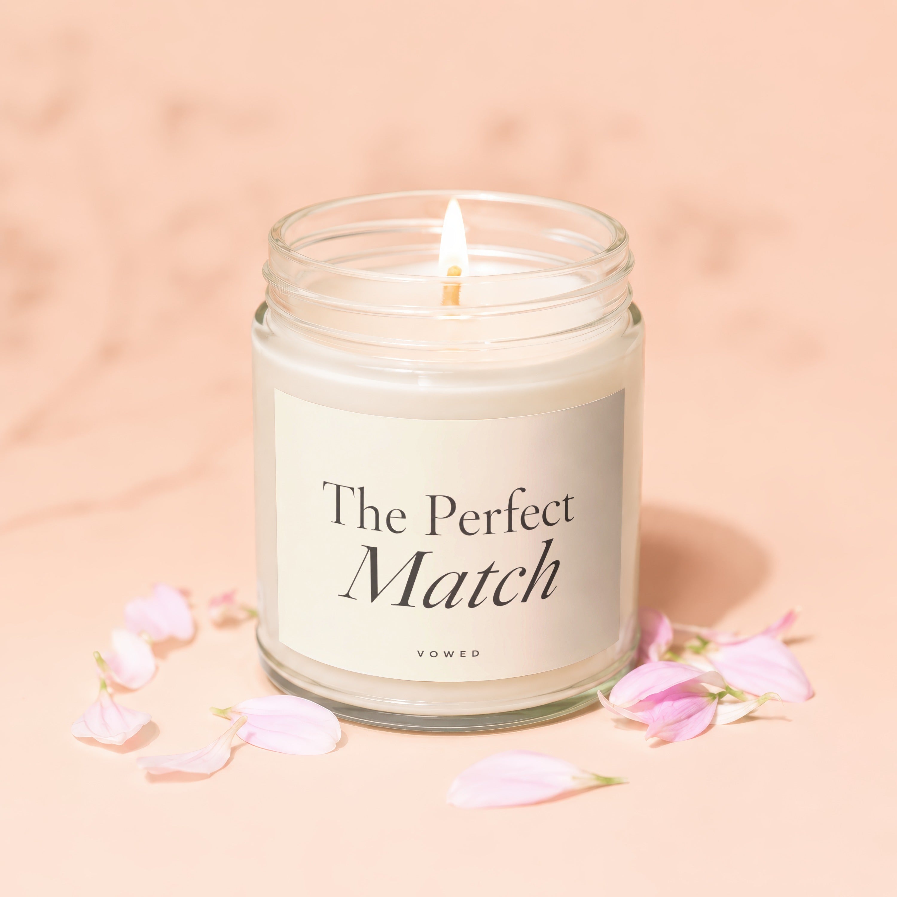 Candle with "The Perfect Match" and "vowed" text, surrounded by pink petals.
