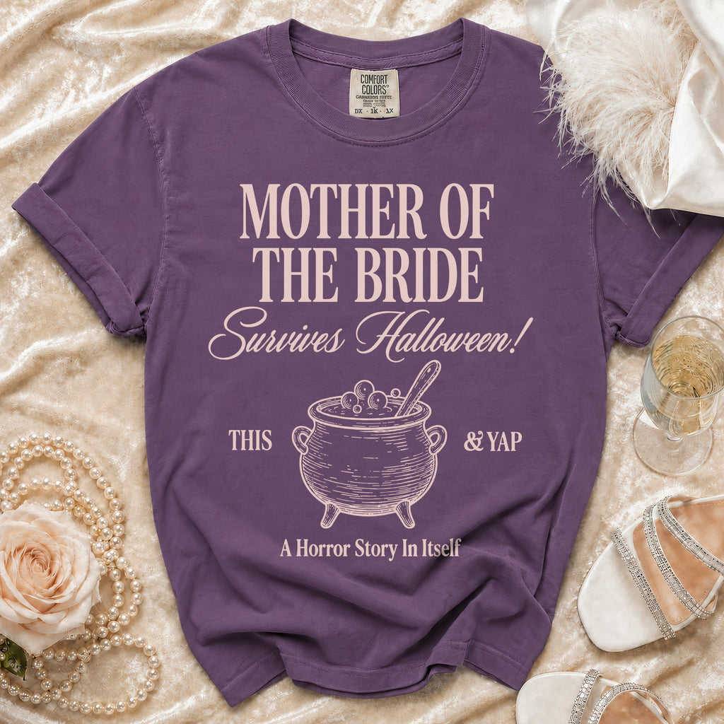 Purple t-shirt with "Mother of the Bride Survives Halloween" and cauldron graphic.