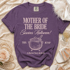 Purple t-shirt with "Mother of the Bride Survives Halloween" and cauldron graphic.