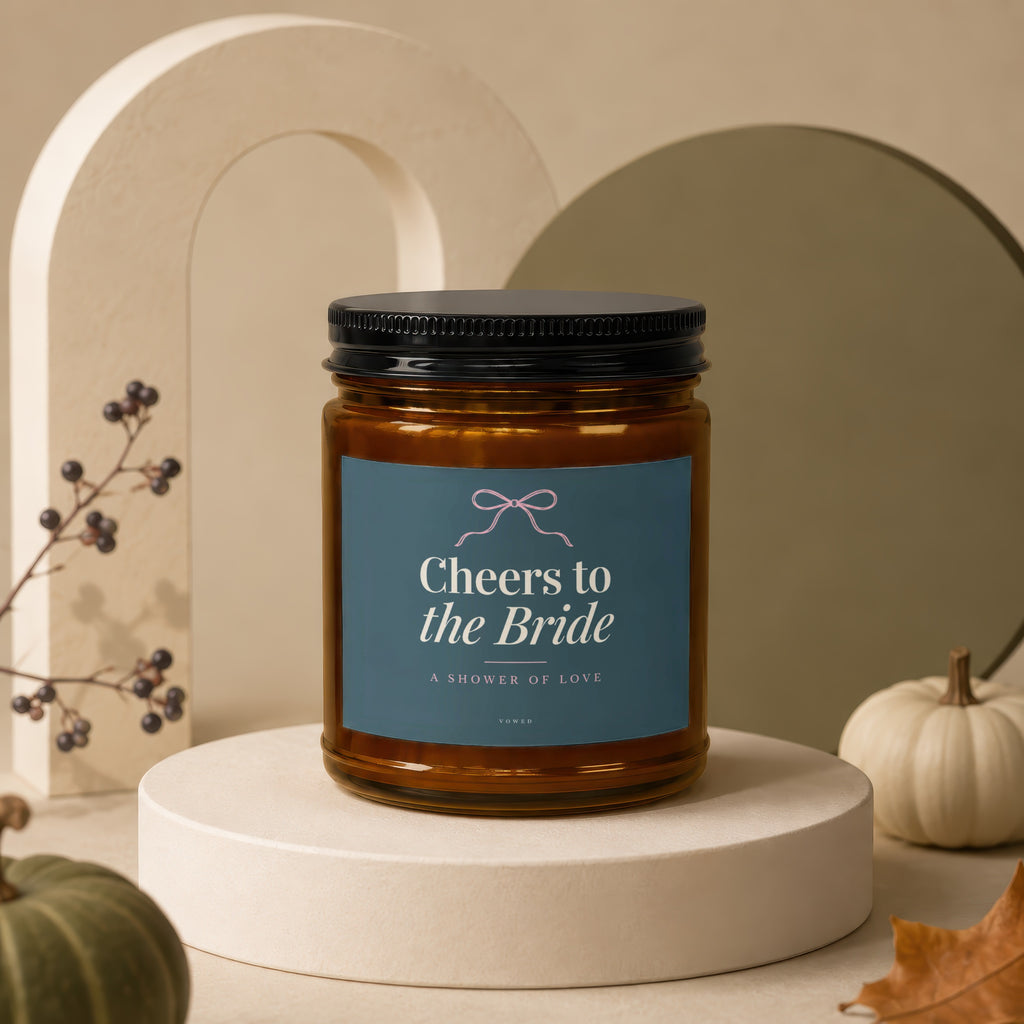 Brown glass candle with "Cheers to the Bride" text on a blue label.
