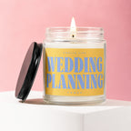 Scented candle with label "Smells Like Wedding Planning Vowed" on pink background