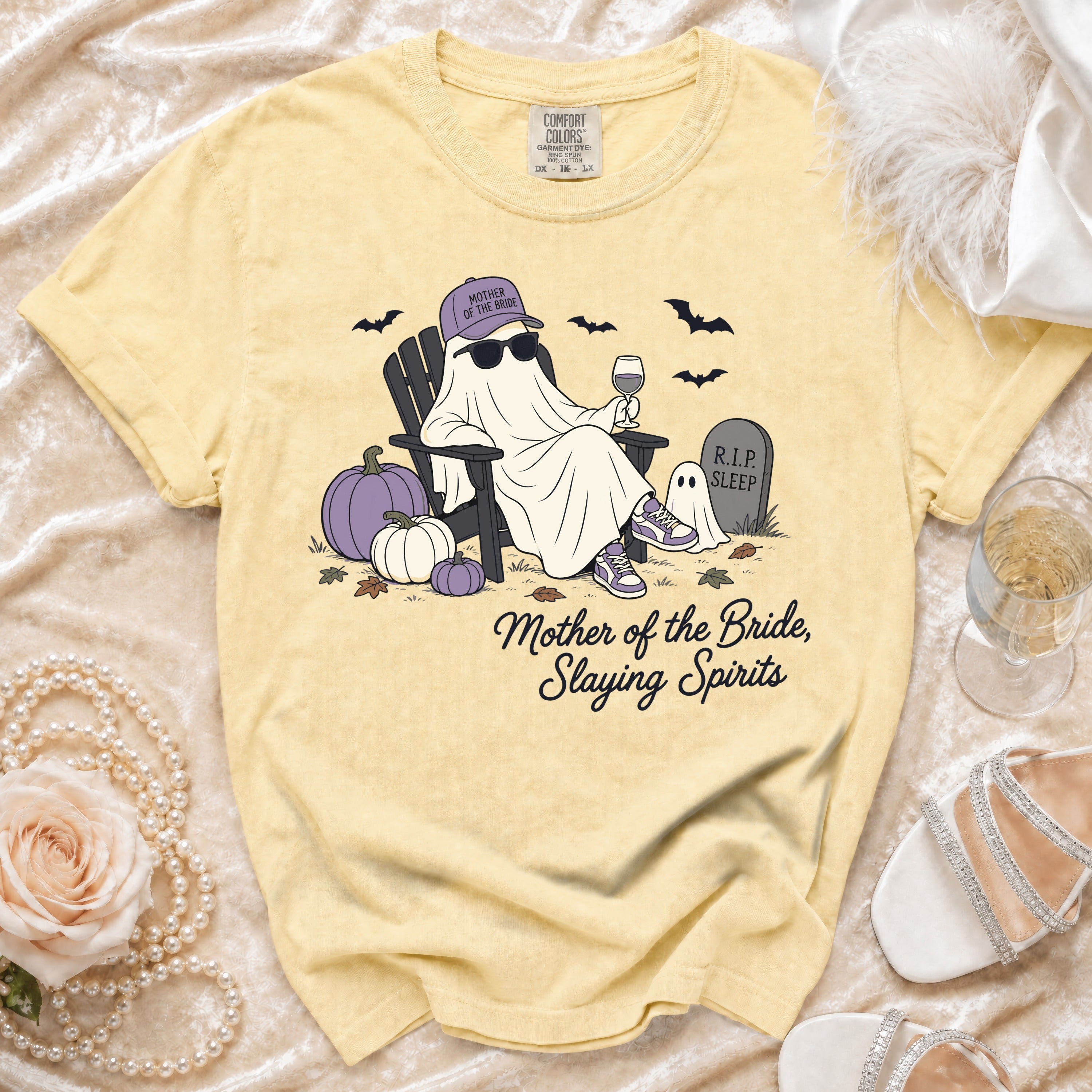 Yellow shirt with a ghost in a chair, wearing sunglasses, a hat, and holding wine. Text says: Mother of the Bride, Slaying Spirits.