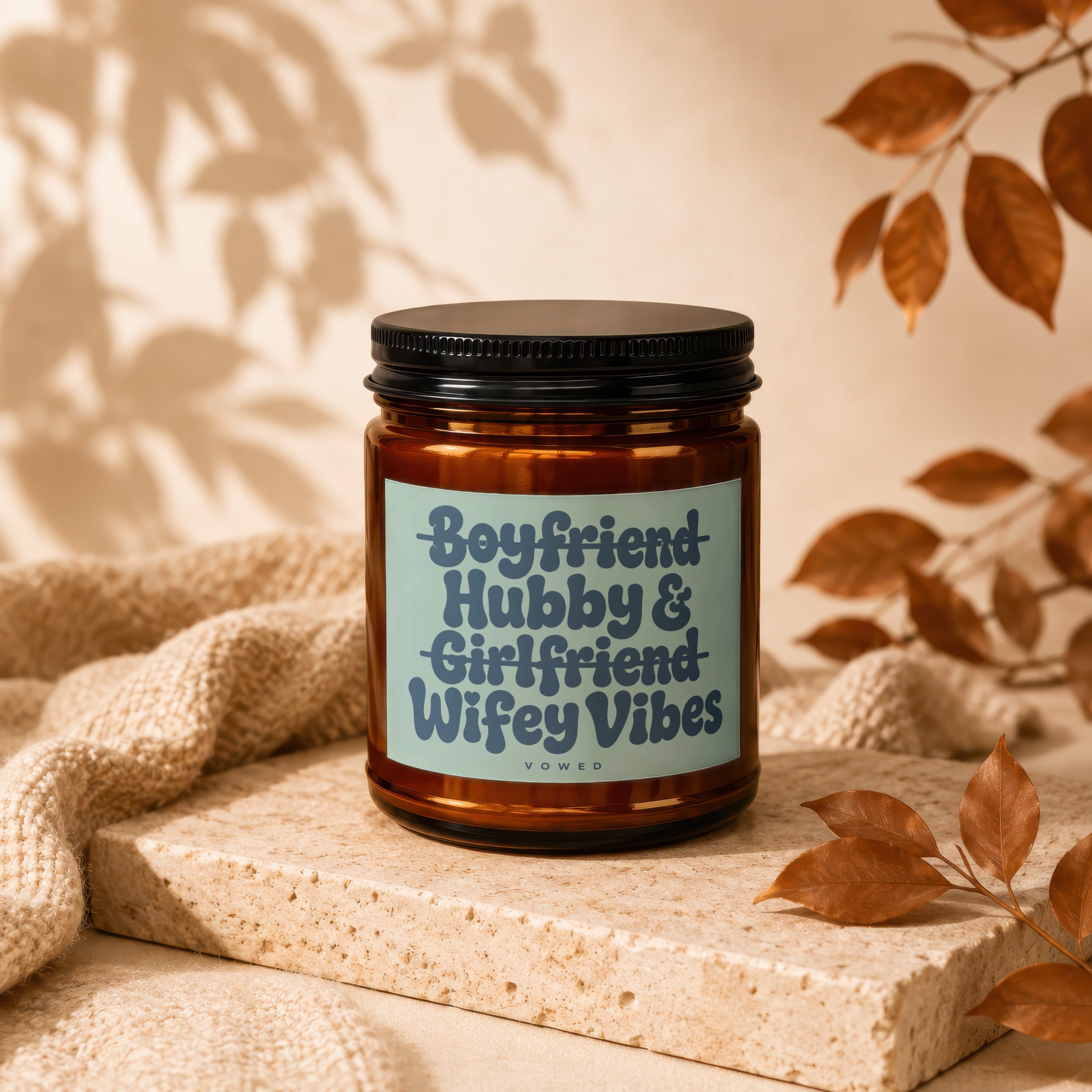 Amber candle jar with a light blue label reading "Boyfriend Hubby & Girlfriend Wifey Vibes".