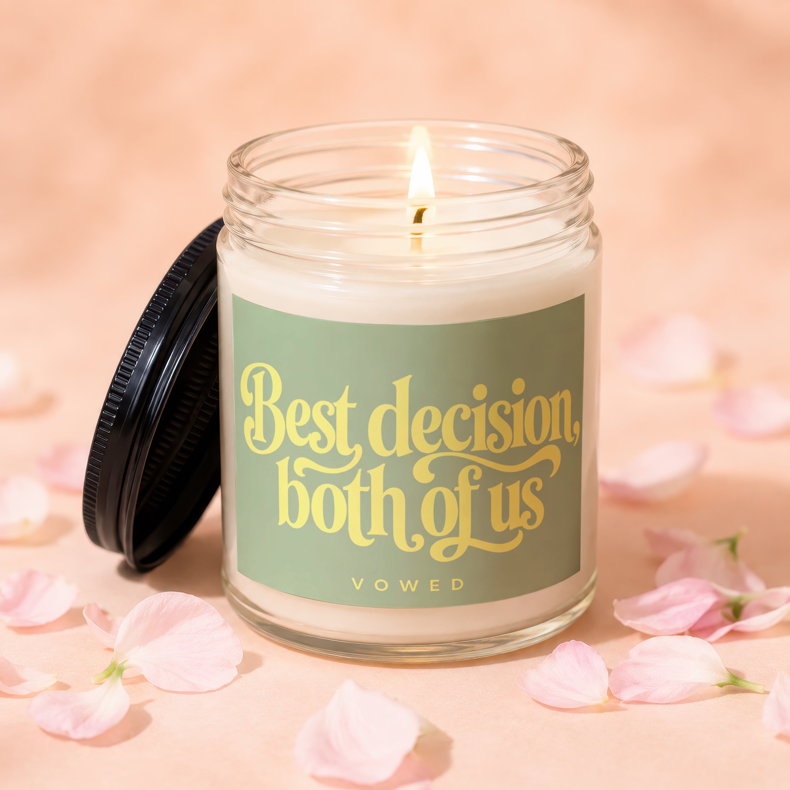Glass candle with lit wick and lid next to it, labeled "Best decision both of us vowed".