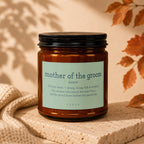 Amber candle with "mother of the groom" definition label and black lid.