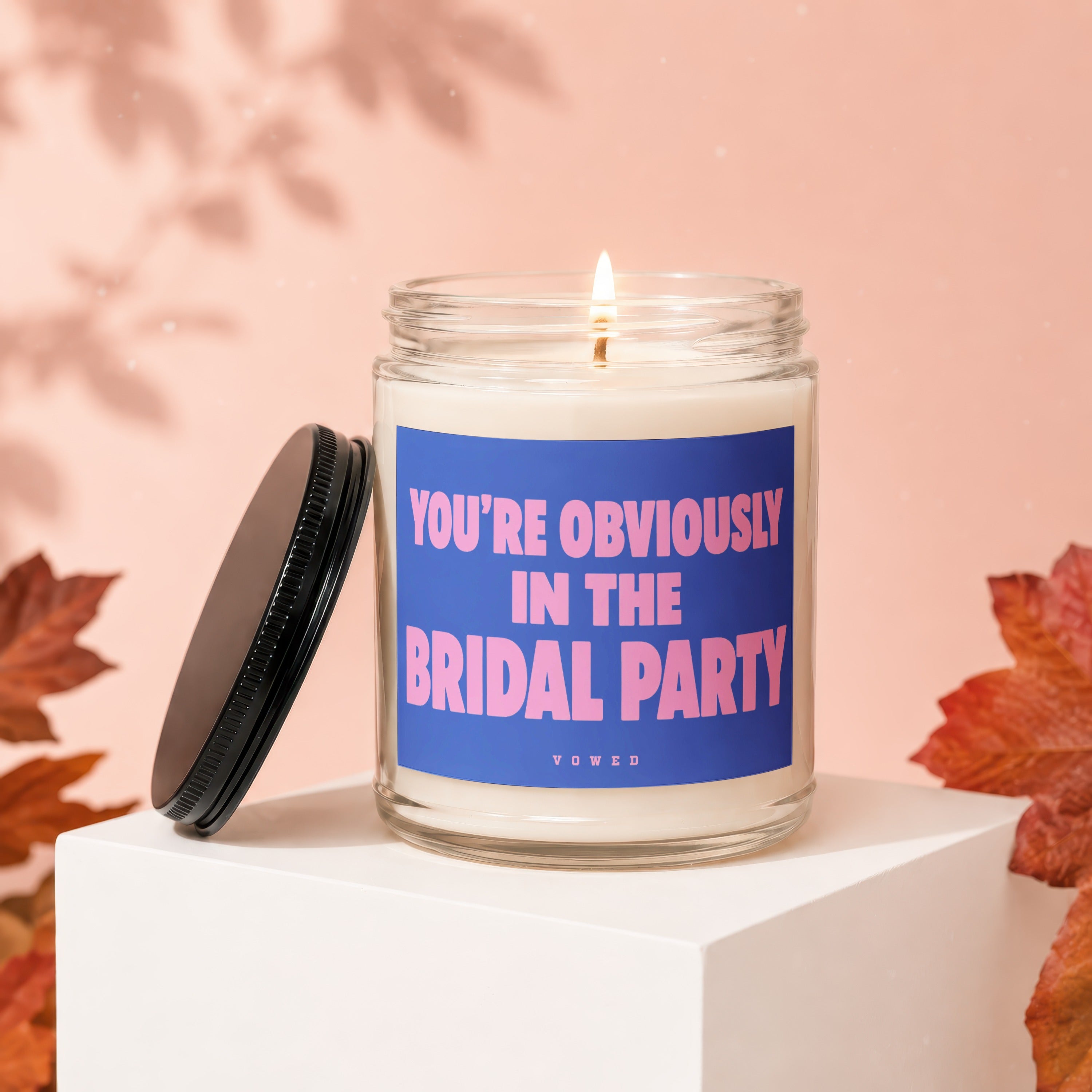 Scented candle with blue label reading "YOU'RE OBVIOUSLY IN THE BRIDAL PARTY".