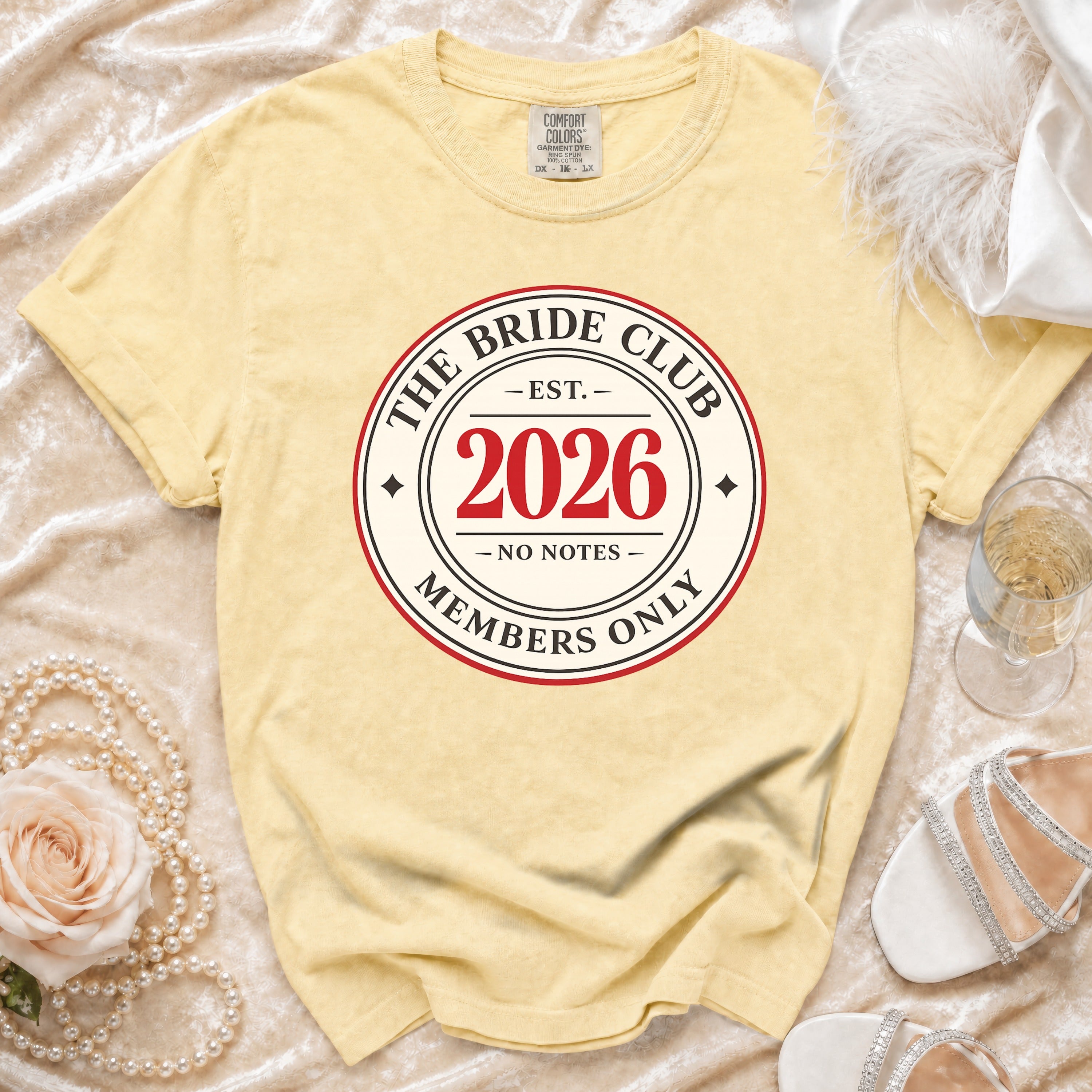 Yellow t-shirt with "The Bride Club Est. 2026 Members Only" graphic.