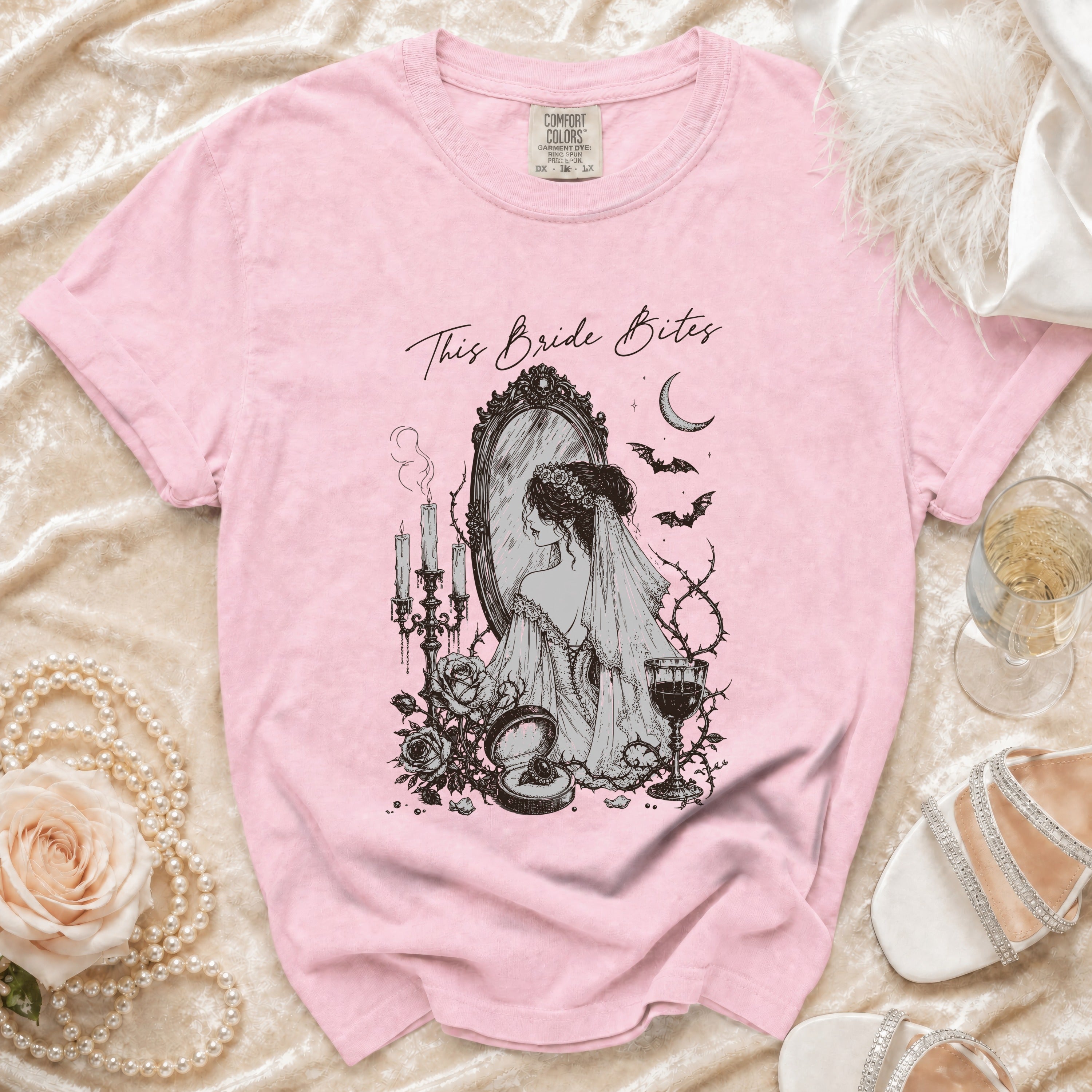 Pink t-shirt with "This Bride Bites" graphic of a bride looking in a mirror.